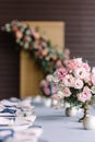 Luxurious wedding table for guests at the wedding. Pink flowers in beautiful vases Royalty Free Stock Photo