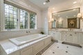 Expensive white bathroom with large rectangular bathtub Royalty Free Stock Photo