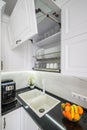 Luxurious white modern kitchen interior, drawers pulled out, doors open Royalty Free Stock Photo
