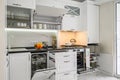 Luxurious white modern kitchen interior, drawers pulled out, oven's door open Royalty Free Stock Photo