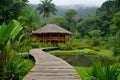 luxurious wood cabin with palm roof in the rainforest, bridges, and pergola, semi circular orchards in tropical garden Royalty Free Stock Photo