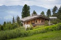 Luxurious wooden chalet house on austrian mountains alps between trees Royalty Free Stock Photo