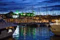 Luxurious yachts and boats in the port at night. evening, pier, sea, and sky