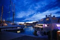 Luxurious yachts and boats in the port at night. evening, pier, sea, and sky