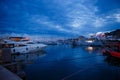 Luxurious yachts and boats in the port at night. evening, pier, sea, and sky