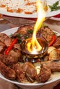 Luxuriously decorated table with roast meat and fire Royalty Free Stock Photo