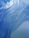 Luxury abstract fluid art painting background alcohol ink technique blue and silver. Swirls of shiny silver edges. Royalty Free Stock Photo