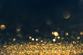 Luxury abstract glitter bokeh background. New year and christmas holiday party design. Golden star dust light sparkling on dark