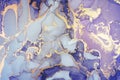 Luxury abstract painting in fluid art technique.Transparent layers of pastel purple and gold paints. Royalty Free Stock Photo