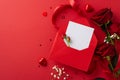 Top view stylish envelope, love letter, heart-shaped chocolates, stunning bouquet of roses, gypsophila, red background Royalty Free Stock Photo