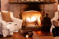 Luxury African Safari lodge interior with vintage white armchairs wooden table and classic fireplace