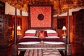 Luxury African tribal hut bedroom interior with old vintage wooden bed and grand wall decoration