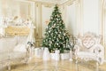 Luxury apartment decorated for christmas. Xmas tree with presents underneath in living room Royalty Free Stock Photo