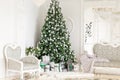 Luxury apartment decorated for christmas. Xmas tree with presents underneath in living room Royalty Free Stock Photo