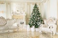 Luxury apartment decorated for christmas. Xmas tree with presents underneath in living room Royalty Free Stock Photo