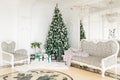 Luxury apartment decorated for christmas. Xmas tree with presents underneath in living room Royalty Free Stock Photo