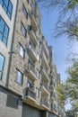 Luxury apartment facade with small balconies and stone brick exterior wall Royalty Free Stock Photo