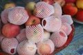 Luxury apples in white jackets, fruits from Asia