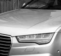 Luxury Audi A8 silver car parked in city car headlight detail