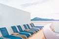 Luxury balcony facing out to open sea with blue beach chair seating for luxury beach vacation concept and background