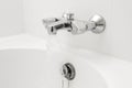 Luxury bath tub and faucet with water. Royalty Free Stock Photo