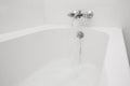 Luxury bath tub and faucet with water. Royalty Free Stock Photo