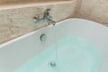 Luxury bath tub and faucet with water Royalty Free Stock Photo
