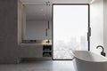 Luxury bathroom interior with bathtub, furniture panoramic window with city view. Royalty Free Stock Photo