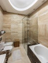 Luxury bathroom interior with glass shower cabin and bathtub Royalty Free Stock Photo