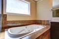 Luxury bathroom interior with white bath tub with marble trim Royalty Free Stock Photo