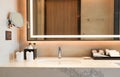 Luxury bathroom marble counter top with faucet, sink , mirror and amenities Royalty Free Stock Photo