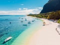 Luxury beach with mountain in Mauritius. Tropical beach with palms and blue ocean with boats. Aerial view Royalty Free Stock Photo
