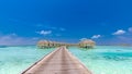 Maldives island, luxury water villas resort and wooden pier. Beautiful sky and clouds and beach background for summer vacation