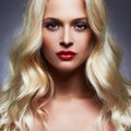 Luxury beautiful young woman with healthy curl blond hair Royalty Free Stock Photo