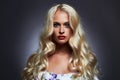 Luxury beautiful young woman with healthy curl blond hair Royalty Free Stock Photo