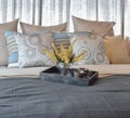 Luxury bedroom interior with striped pillows and decorati