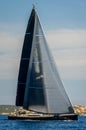 Luxury big sailing yacht with black sails vertical photo.