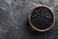 Luxury black sturgeon caviar wooden bowl, dark texture backdrop