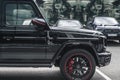 Luxury black SUV Mercedes-Benz G Class Gelandewagen parked next to Moscow City business center. Front part of car, side view Royalty Free Stock Photo