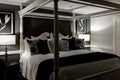 Luxury black and white master bedroom with a four poster bed Royalty Free Stock Photo