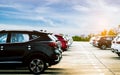 Luxury black, white and red new suv car parked on concrete parking area at factory with blue sky and clouds. Car stock for sale. Royalty Free Stock Photo