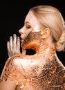 Luxury blonde girl with creative makeup and gold foil on her neck and back Royalty Free Stock Photo