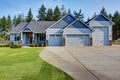 Luxury blue house with curb appeal. Three car garage.