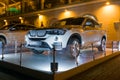 Luxury Bmw x4 at night, new model of the brand BMW near the dealers showroom.