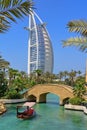 Luxury boat cruise on traditional abra skiff on Madinat Jumeirah canals with view to famous Burj al Arab Hotel. Dubai Royalty Free Stock Photo