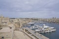 Boats moored alongside Fort Saint Angelo in Valetta, Malta Royalty Free Stock Photo