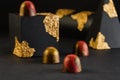 Luxury bonbons with red and gold splashes on black background wi Royalty Free Stock Photo