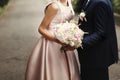 Luxury bride and groom holding hands and gorgeous pink and white Royalty Free Stock Photo