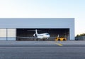 Luxury business jet is being towed out of the hangar Royalty Free Stock Photo