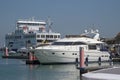 Luxury cabin cruiser and toro ferry at Yarmouth harbour, UK Royalty Free Stock Photo